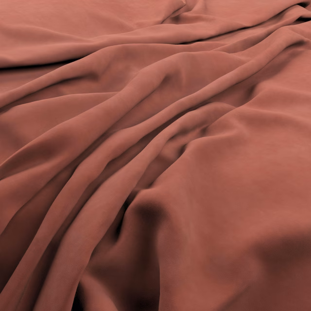 Warm brick-terracotta fabric with a smooth lustrous surface gathered into deep folds