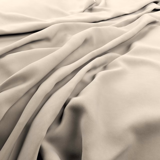 Warm ecru plain fabric falling in softly lustrous, sculptural folds
