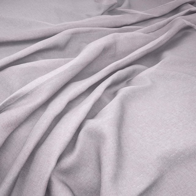 Pale petal-pink fabric with a fine woven texture draped in soft fluid folds