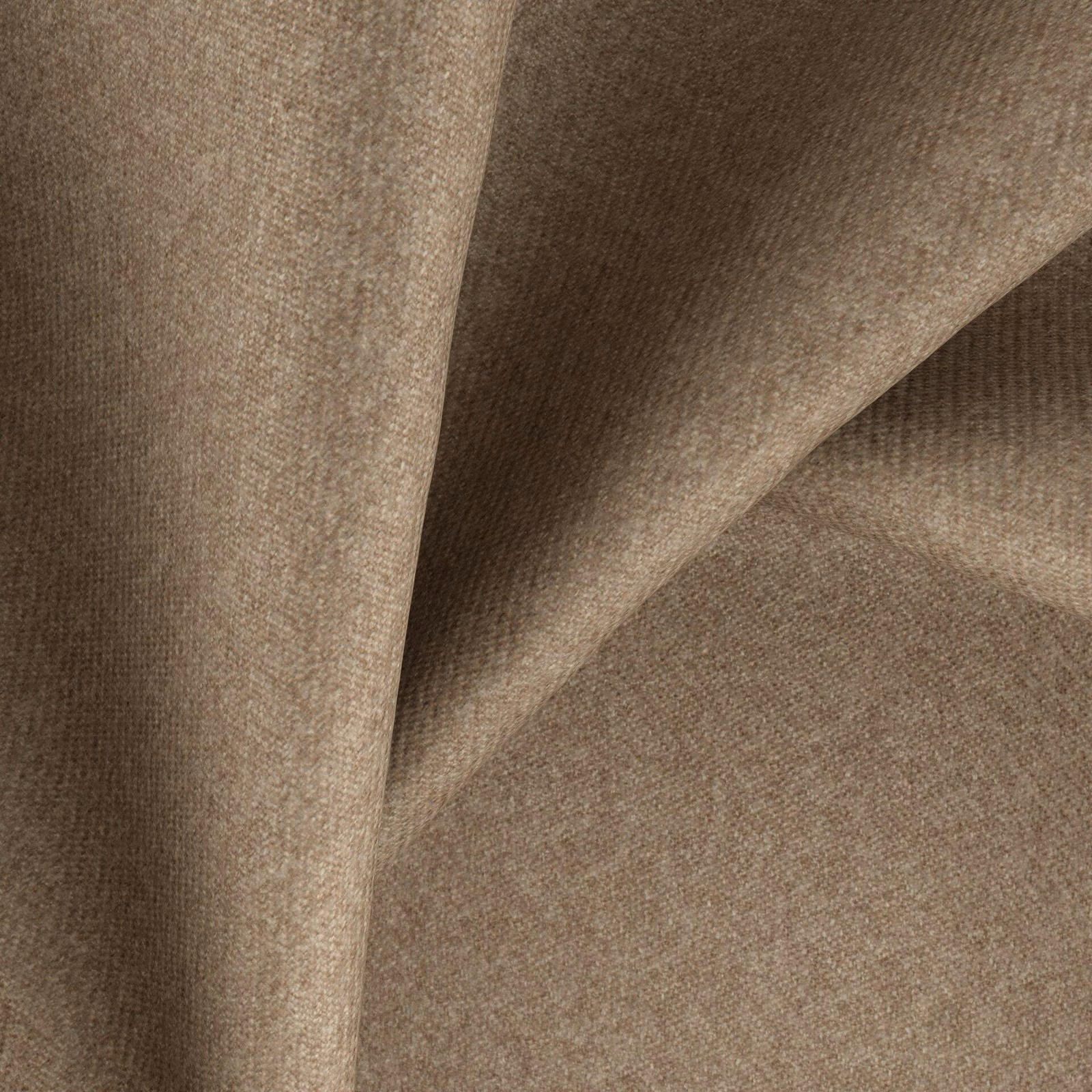 Warm biscuit-beige woven textile showing fine texture and folded tonal shadows