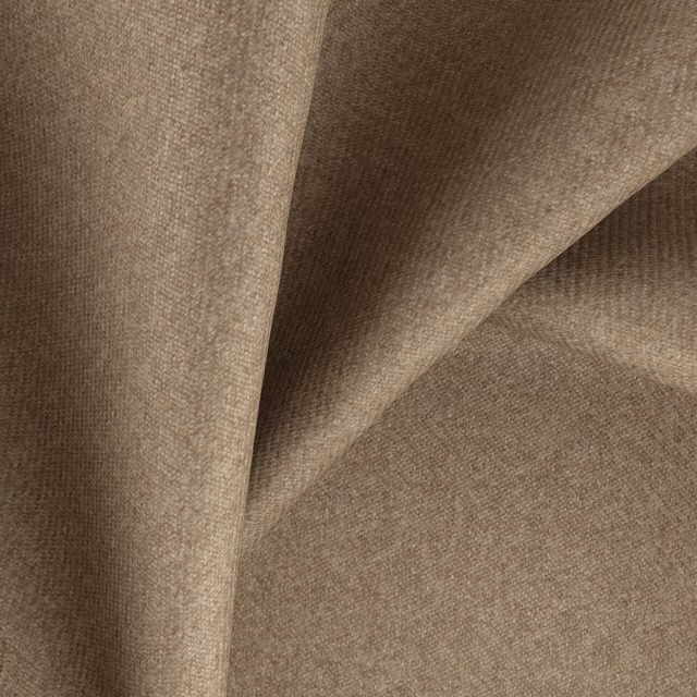 Warm biscuit-beige woven textile showing fine texture and folded tonal shadows