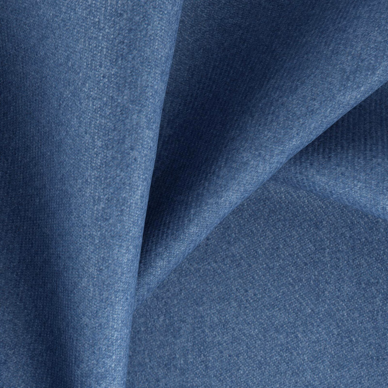 Close view of muted cadet-blue woven fabric falling into softly shaded folds