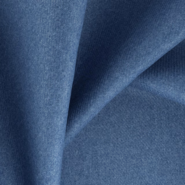 Close view of muted cadet-blue woven fabric falling into softly shaded folds
