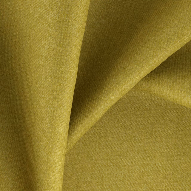 Close view of muted lime-olive woven fabric with fine texture and soft folds