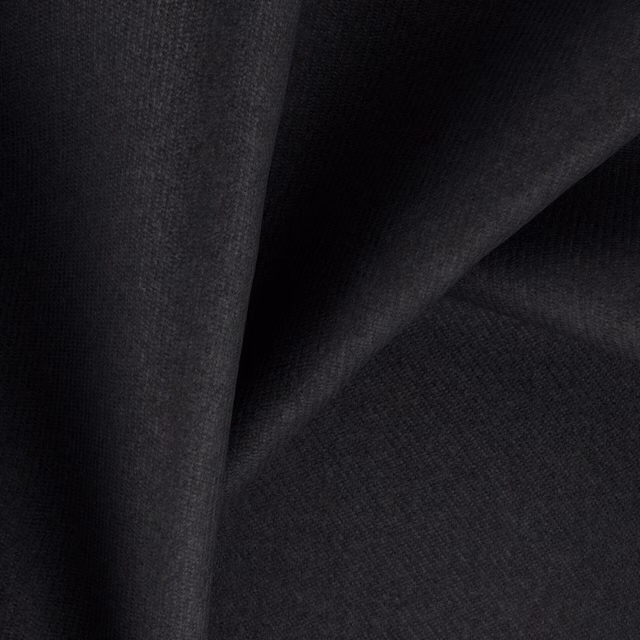 Folded near-black charcoal fabric showing a fine, subtly shifting woven texture
