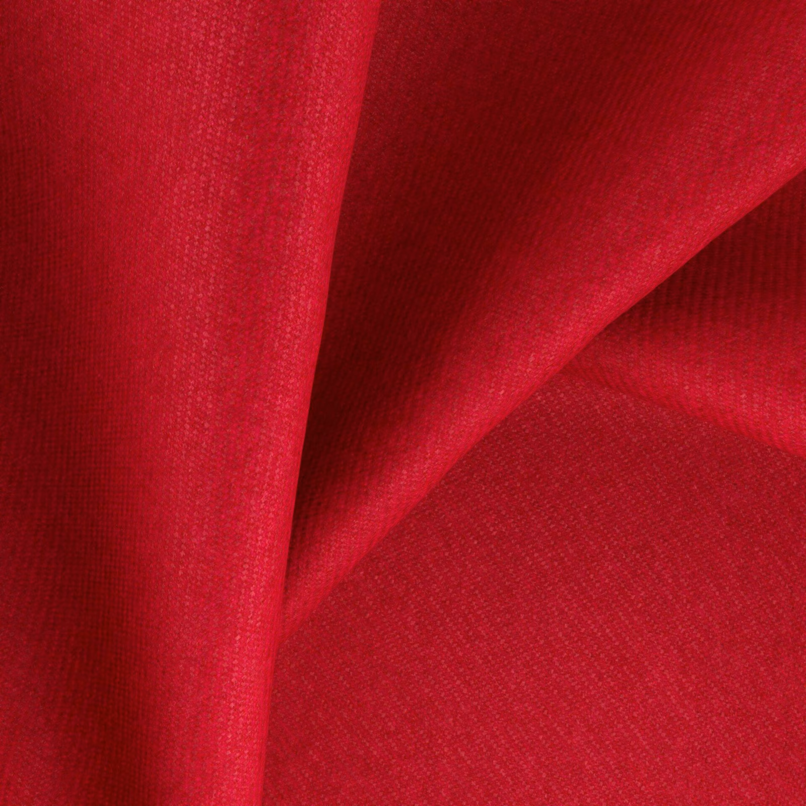 Saturated pillarbox red woven fabric folded to show its fine textured surface