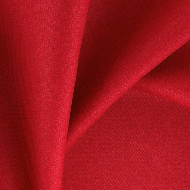 Saturated pillarbox red woven fabric folded to show its fine textured surface