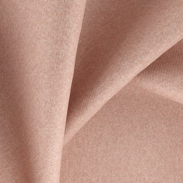 Dusty blush-pink woven fabric with a fine even texture folded into soft shadows
