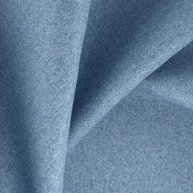 Close-up of muted sea-blue woven fabric with softly mottled blue-grey texture