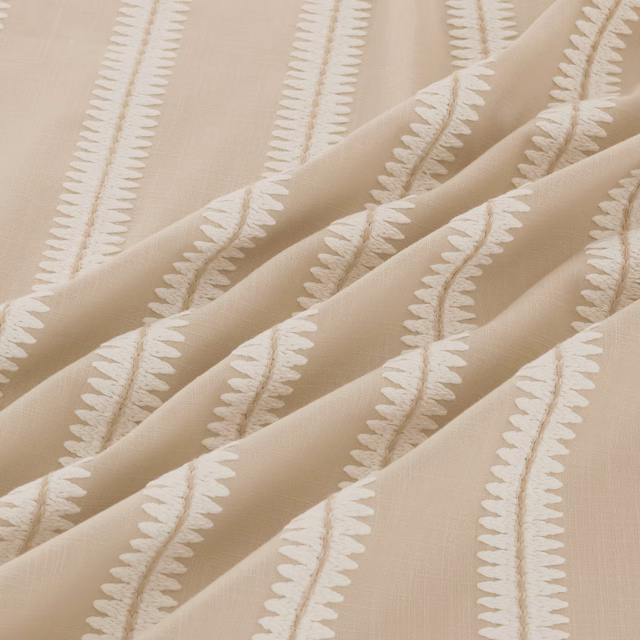 Warm taupe fabric with raised ivory leafy stripes falling in soft folds