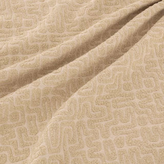 Warm sand-beige woven fabric with raised abstract maze pattern in soft folds