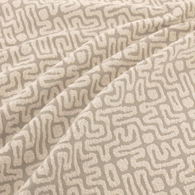 Warm greige taupe woven swatch with raised ivory maze-like lines and soft folds