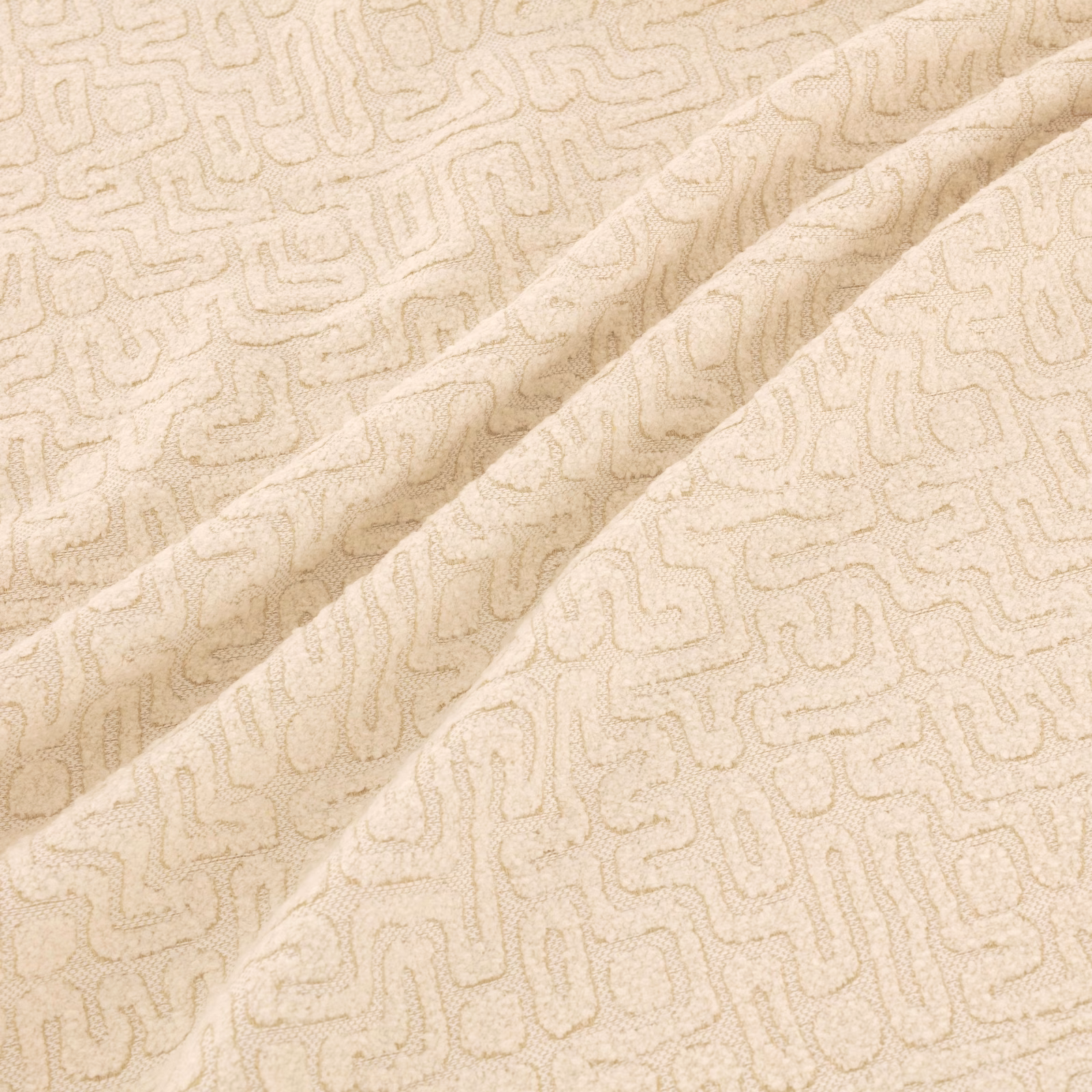 Warm ivory-beige woven swatch with a fine looping geometric maze motif