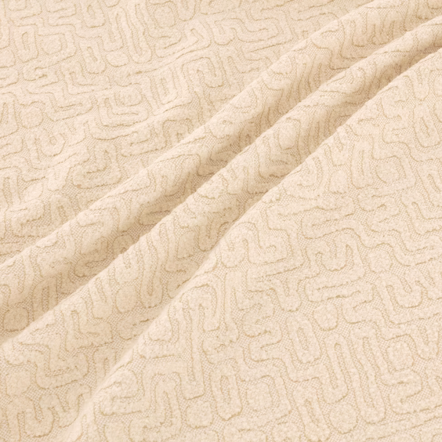 Warm ivory-beige woven swatch with a fine looping geometric maze motif