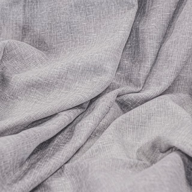 Pale mercury-grey fabric with fine crosshatch weave gathered into fluid folds