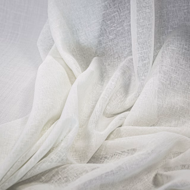Sheer ivory-white open weave gathered into softly translucent folds