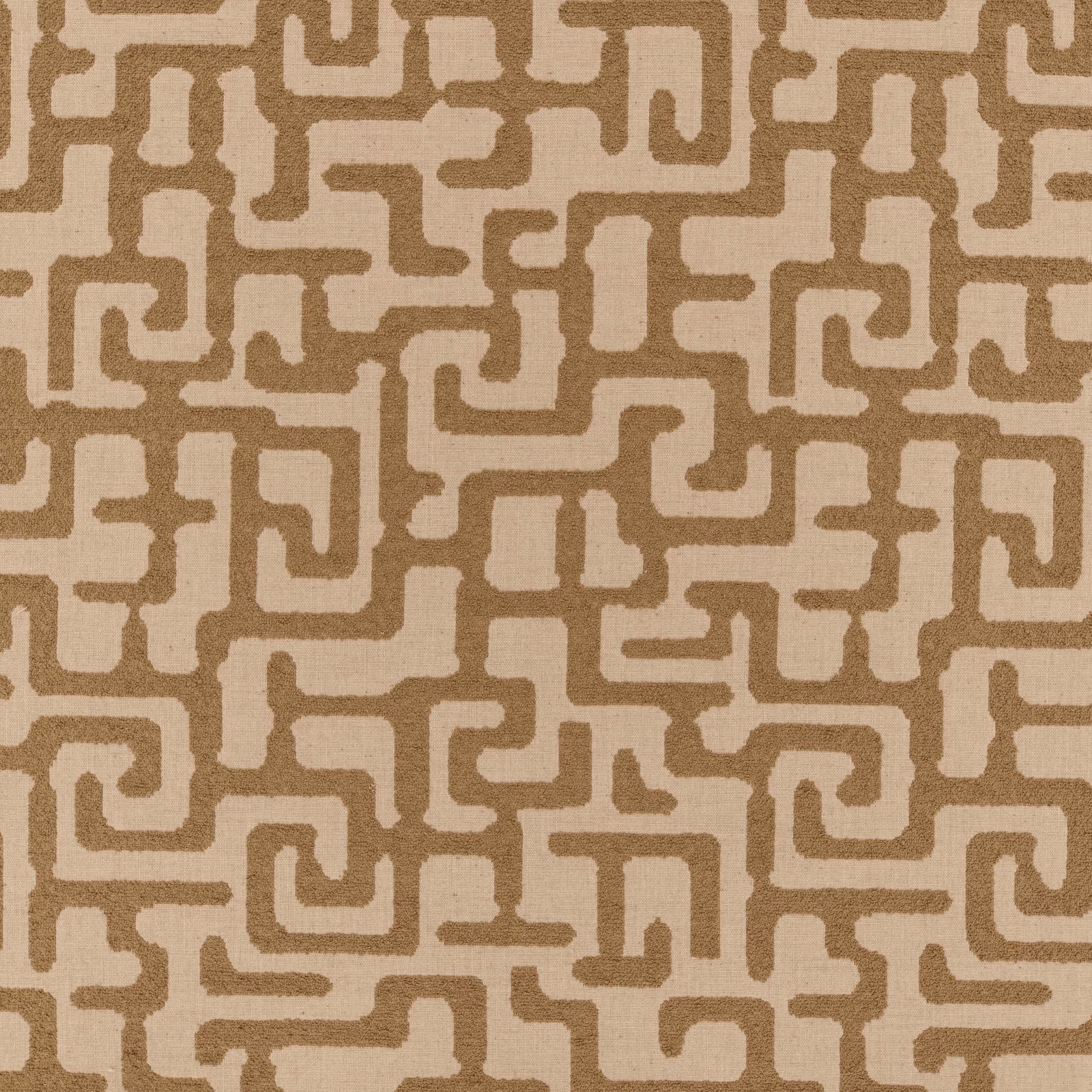 Warm taupe and cream fabric with a textured interlocking geometric meander