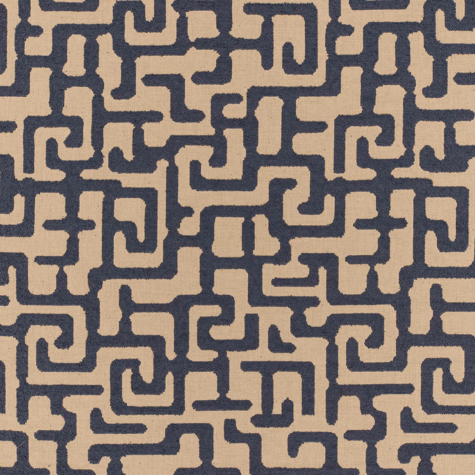 Warm beige woven fabric with dense deep navy interlocking maze motifs