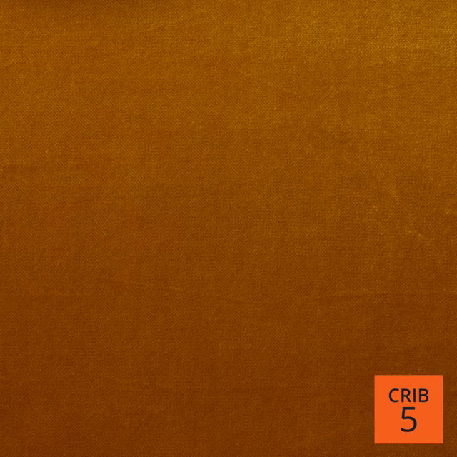 Close-up of amber-gold Mystere fabric with fine, softly mottled woven texture