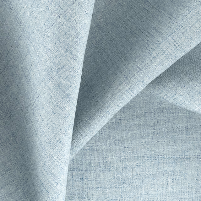 Pale blue-grey textile with fine crosshatched weave folded into soft pleats