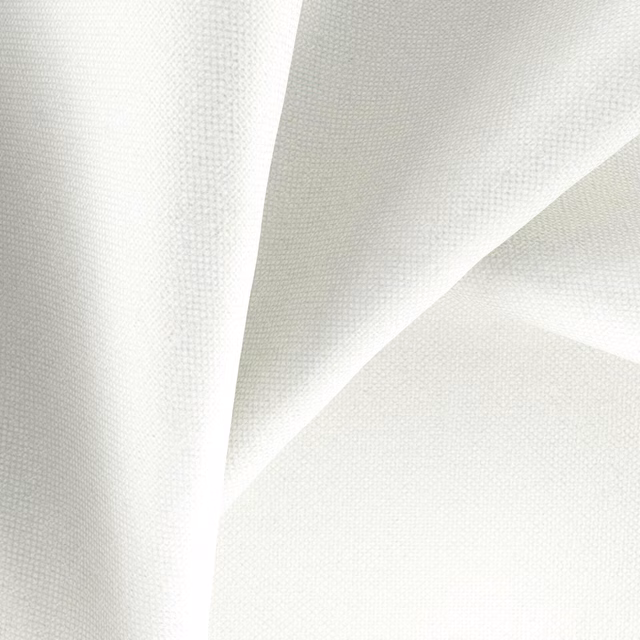 Close-up of snow-white fabric with a fine, softly shadowed woven texture