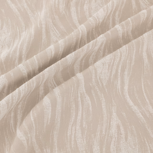Warm ivory fabric with flowing tonal wave striations and softly raised woven texture