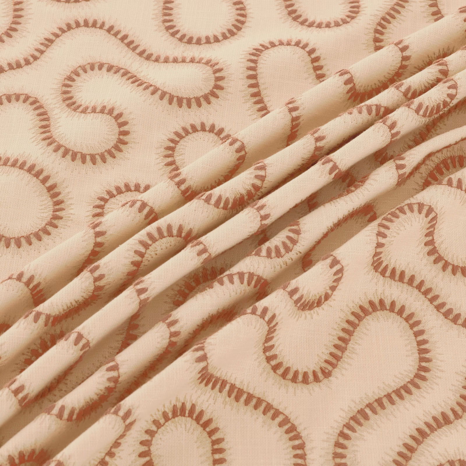 Warm ivory woven fabric with terracotta paisley loops and soft folded texture