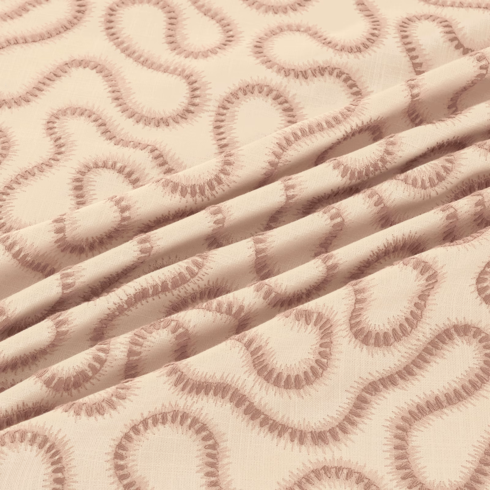Warm cream woven fabric with dusty blush looping motifs and softly ridged texture