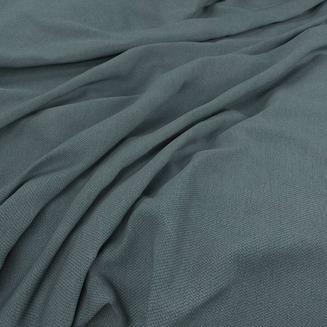 Muted airforce blue-grey fabric showing fine woven texture across soft folded cloth