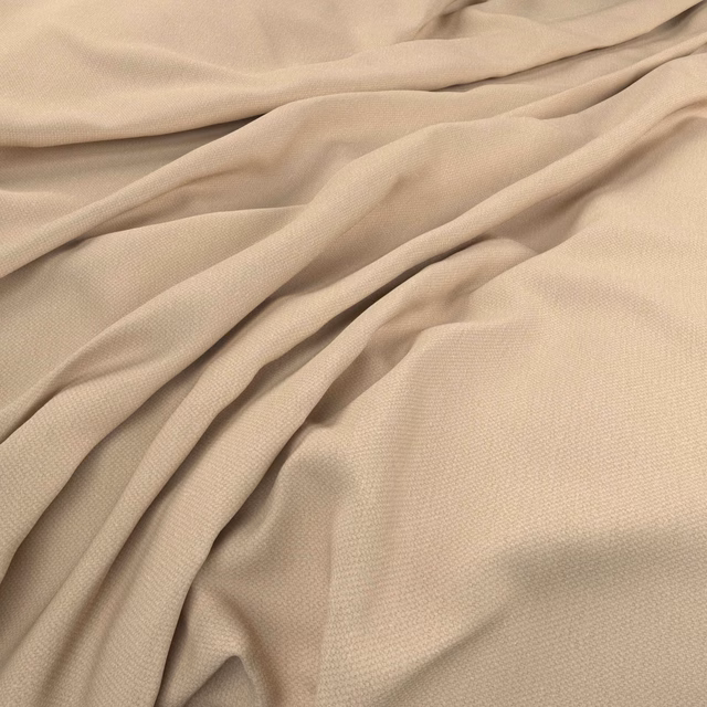 Warm butter-beige woven fabric with fine texture in soft flowing folds
