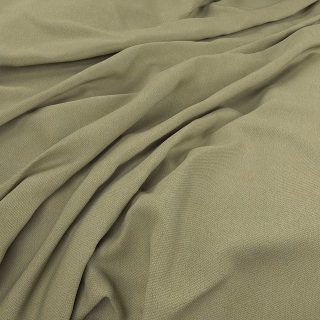 Muted celery-green fine weave gathered into softly shadowed flowing folds