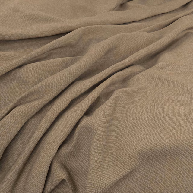 Warm taupe-beige woven cloth gathered into softly shadowed, fluid folds