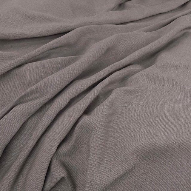 Soft dove grey plain weave fabric with warm taupe undertones arranged in flowing folds