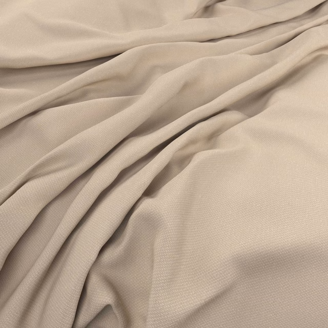Warm ecru woven fabric draped in soft folds, showing a fine surface texture
