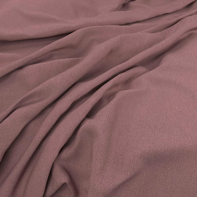 Dusty mauve woven fabric gathered into soft, shadowed folds