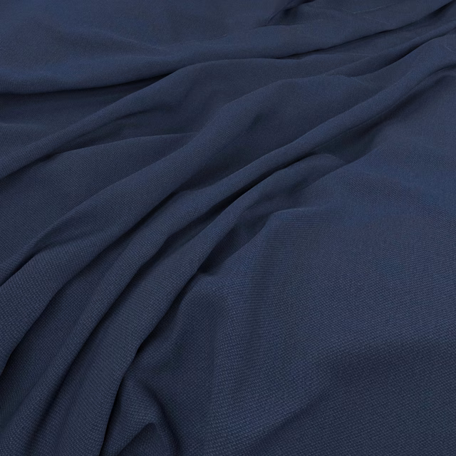 Deep indigo blue fine weave gathered into soft, low-sheen folds