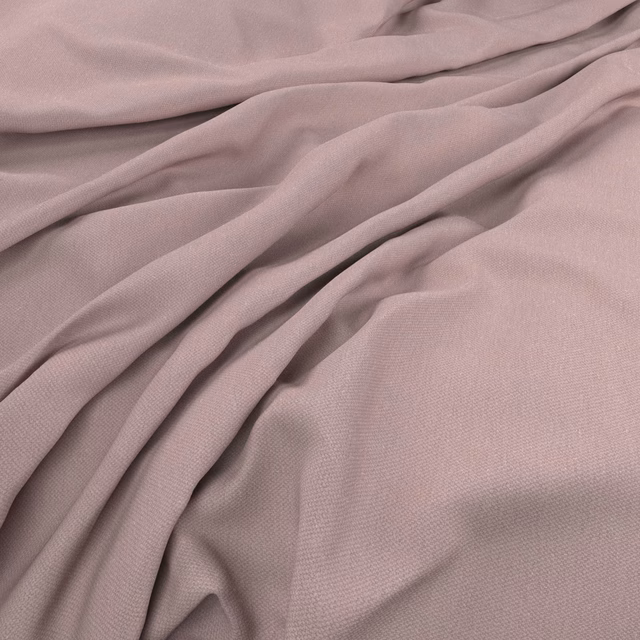 Dusty lavender plain weave fabric falling in soft, fluid folds