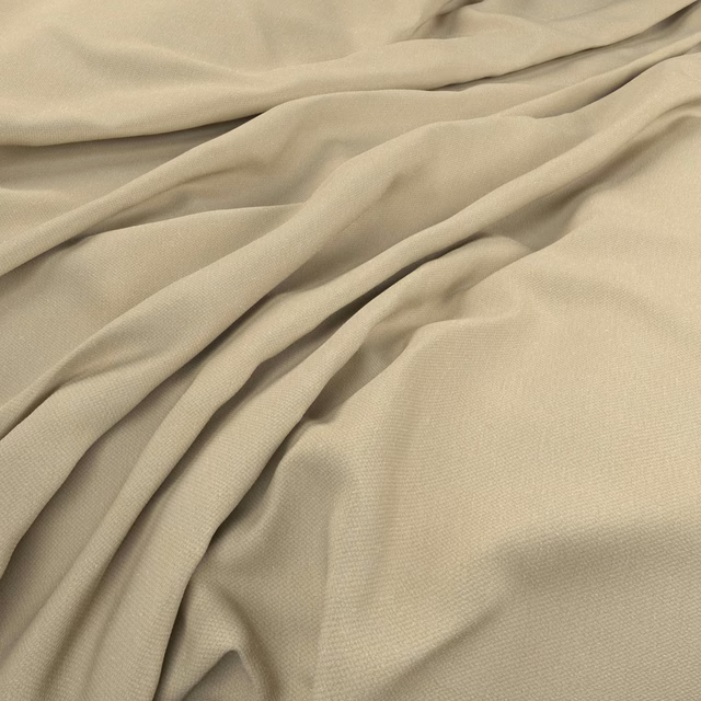 Pale lemongrass beige woven fabric gathered into soft flowing folds