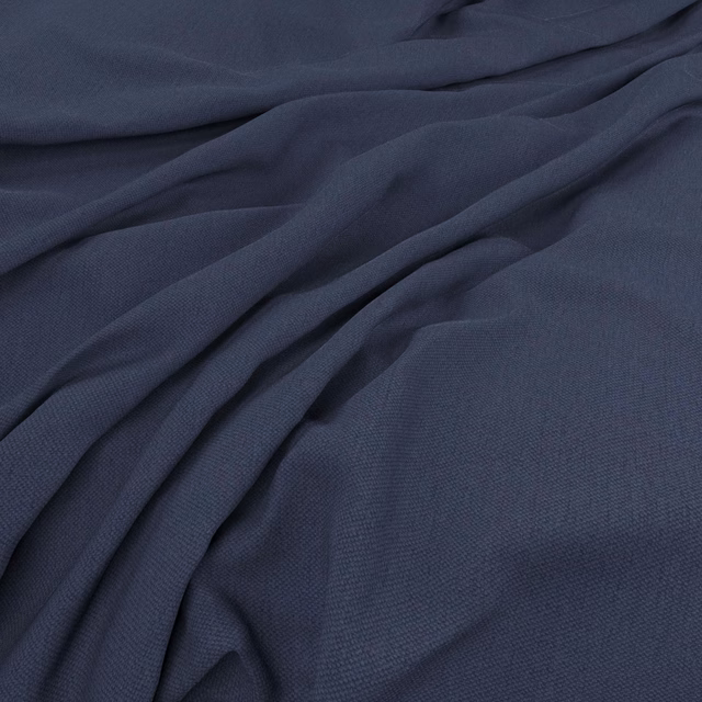 Deep ink navy plain-weave fabric draped in soft folds with subtle slate highlights
