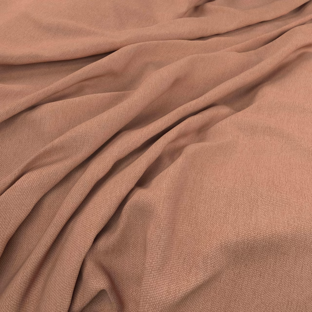Muted peony-pink plain weave fabric gathered into soft, flowing folds