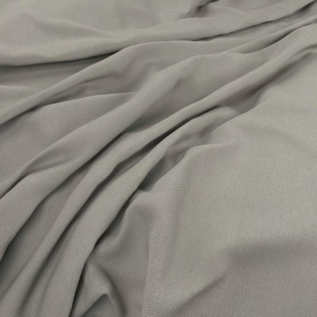 Cool smoke-grey plain weave gathered into fluid, shadowed folds
