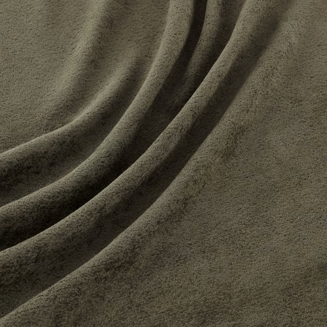Close view of muted olive basil-green velvety pile falling into deep diagonal folds