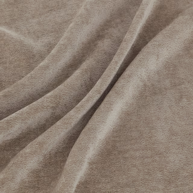 Warm mushroom-beige short-pile fabric gathered into softly shaded folds