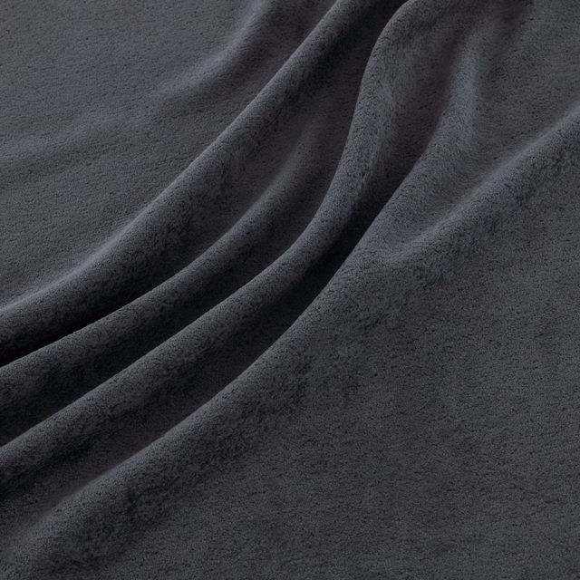 Deep charcoal-indigo fabric with a soft brushed surface falling in broad folds