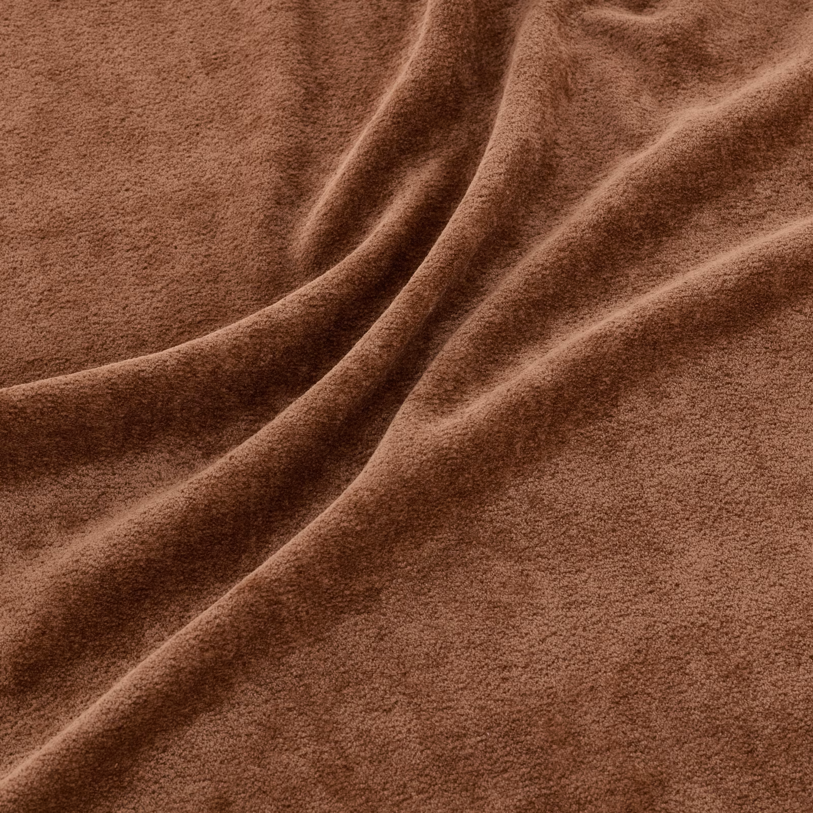 Warm pumpkin-brown plush fabric with softly brushed, velvety texture and draped folds