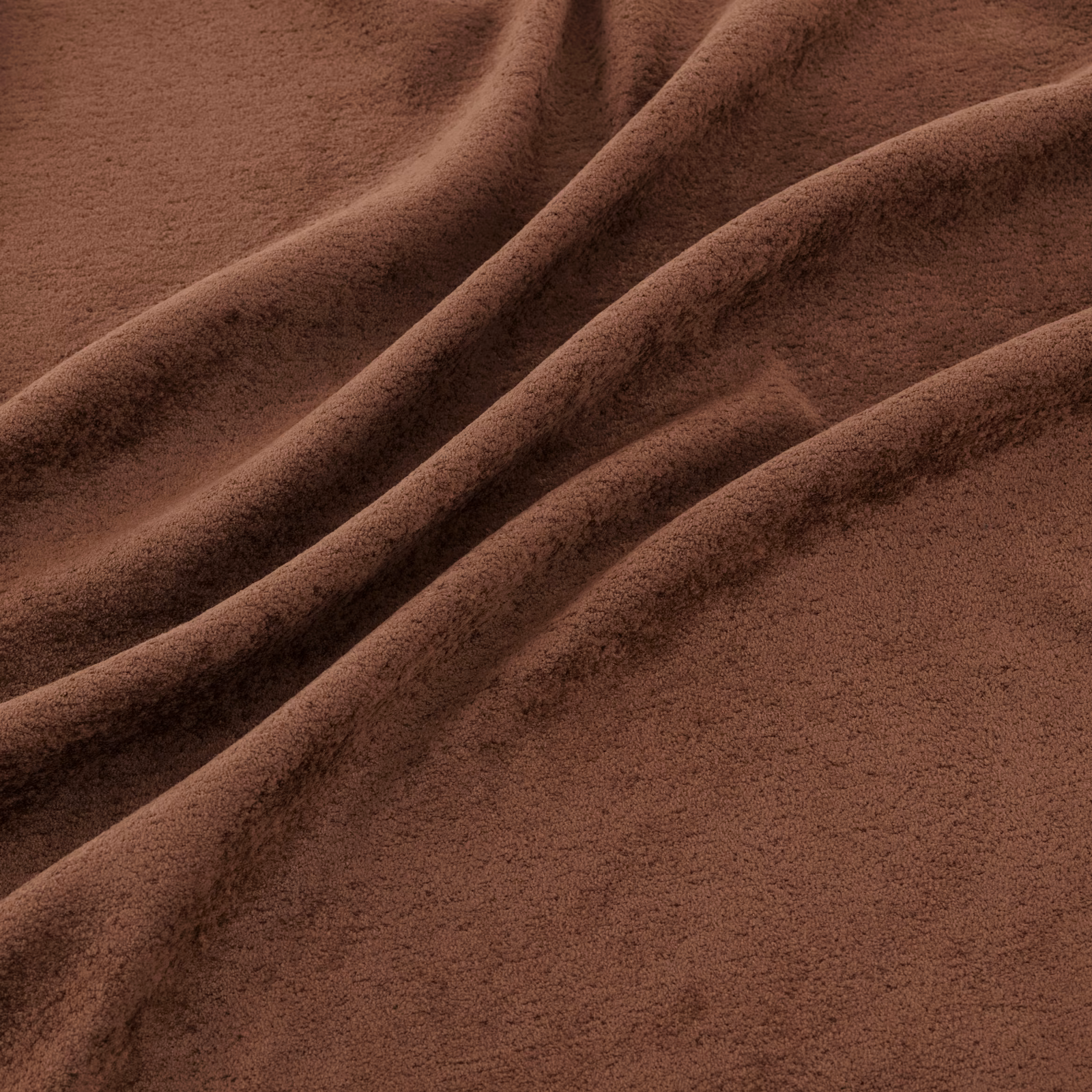 Warm sienna-brown fabric with plush nap and deep diagonal folds