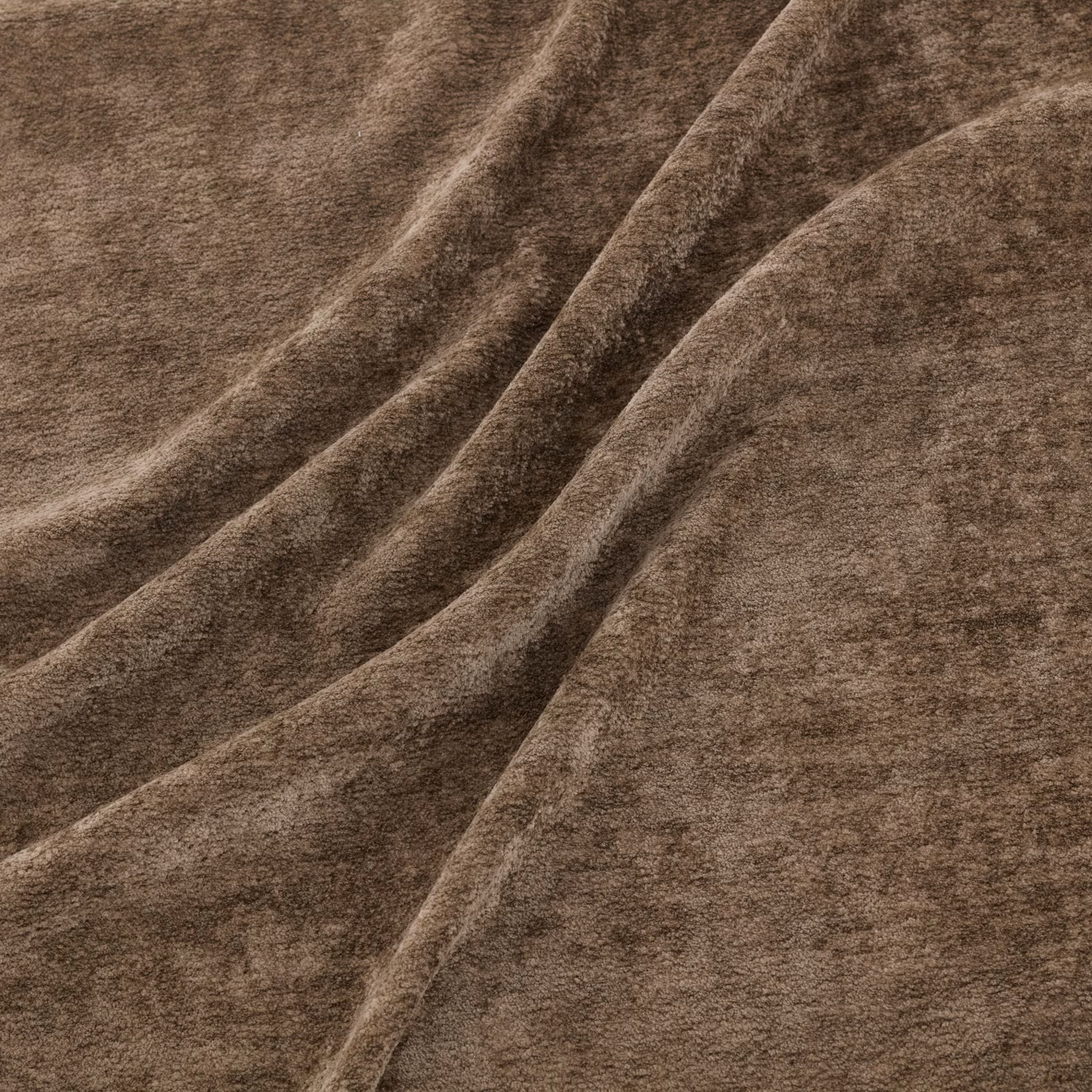 Warm tawny-brown napped fabric with soft diagonal folds and plush surface