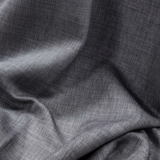Charcoal-grey Parga fabric showing fine woven texture across softly folded cloth