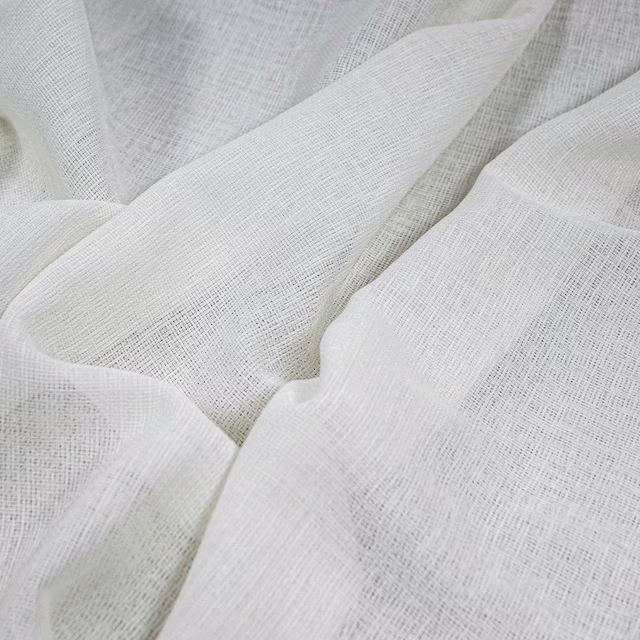 Cool optic-white fabric with a fine open crosshatch weave in soft folds