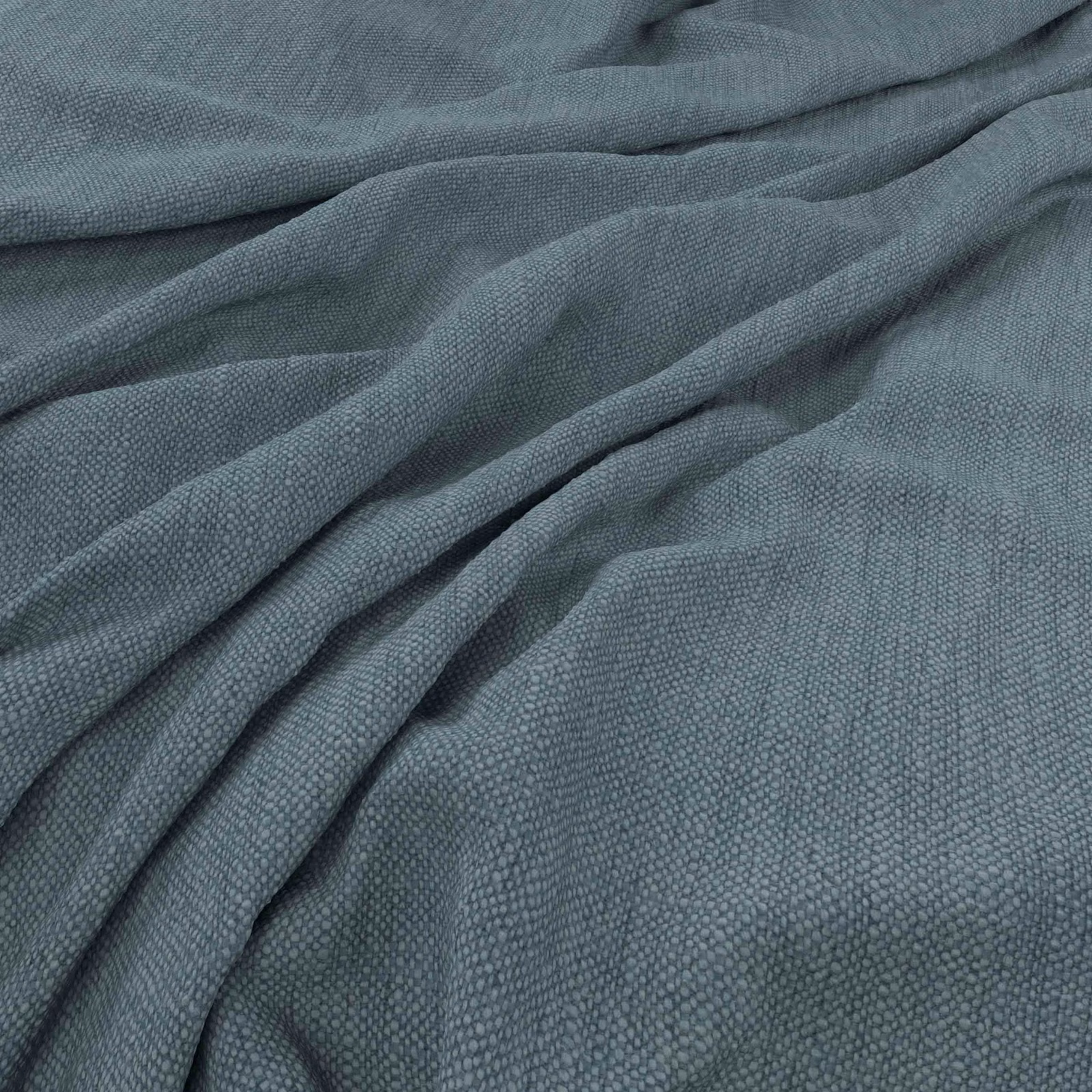 Muted blue-grey woven textile with fine pebbled texture arranged in soft folds